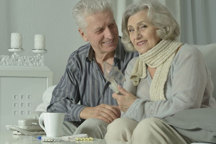 Ein älteres Ehepaar zeigt wie man bei einer Erkältung richtig inhaliert